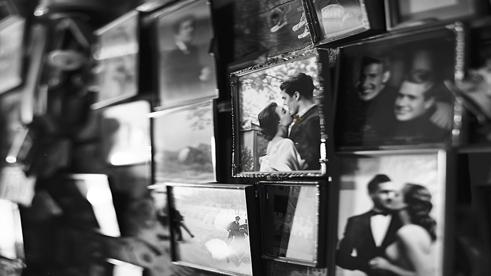 A contact sheet of black and white music photographs on a paper-strewn desk